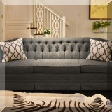 F24. Three-cushion tufted sofa with Perennials indoor/outdoor fabric. 32”h x 92”w x 36”d 